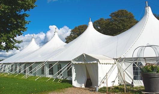 a row of portable restrooms placed outdoors for attendees of a event in Veyo